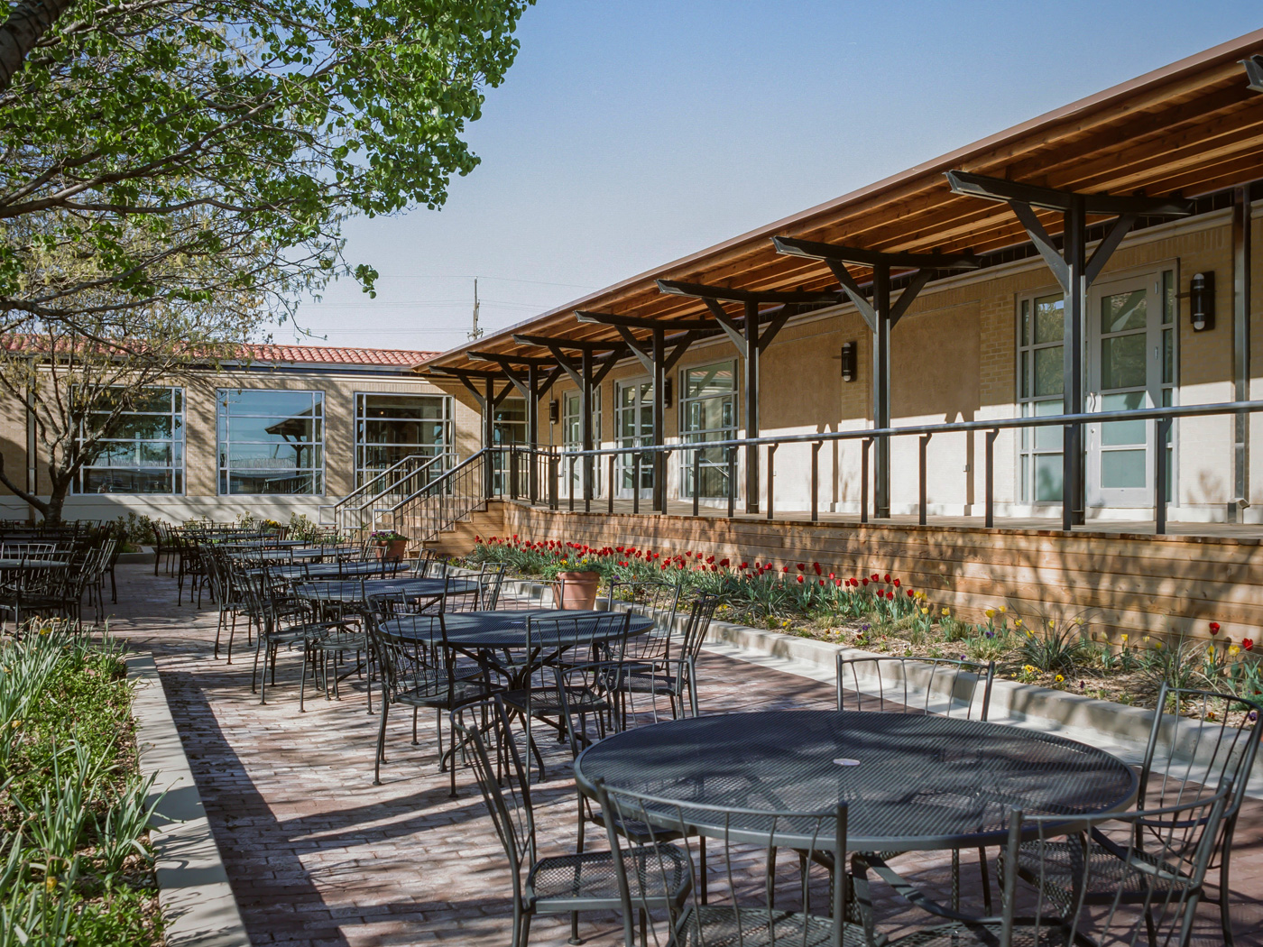 Large patio seating area outside building.