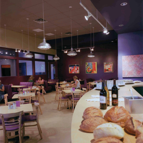 bread lining the counter of a cafe.