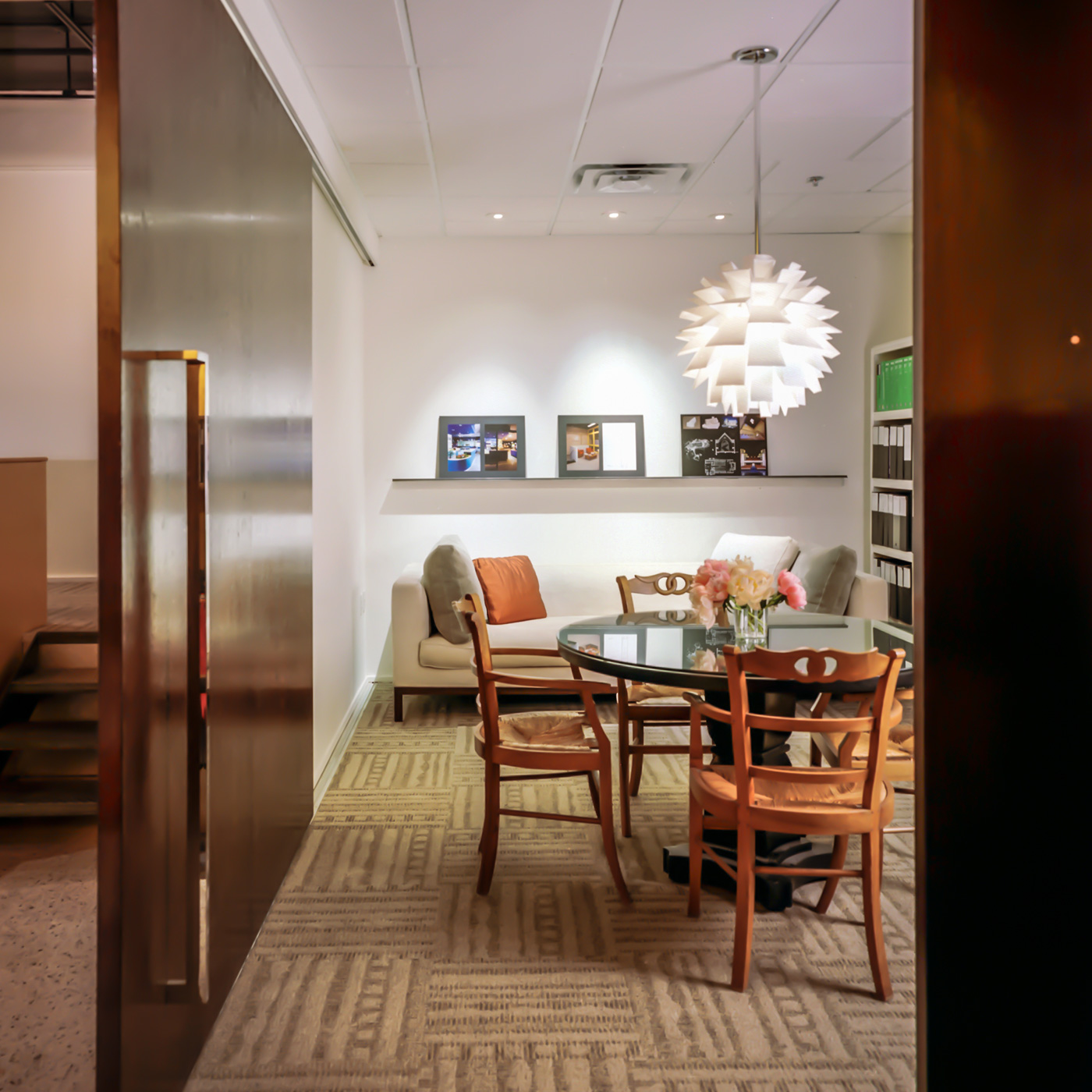 A homey table and love seat in an office building.
