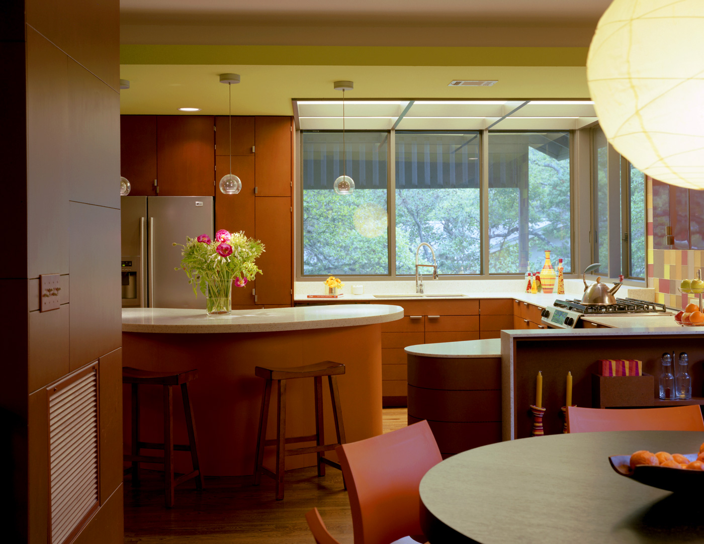 A second-floor kitchen and corner windows to a backyard.