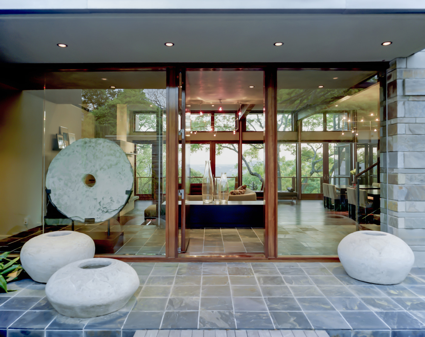 Modern stone homes glass entrance.