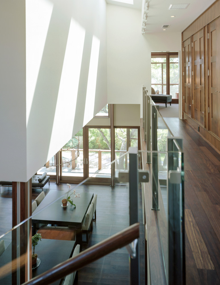 Glass railing of a houses interior balcony.