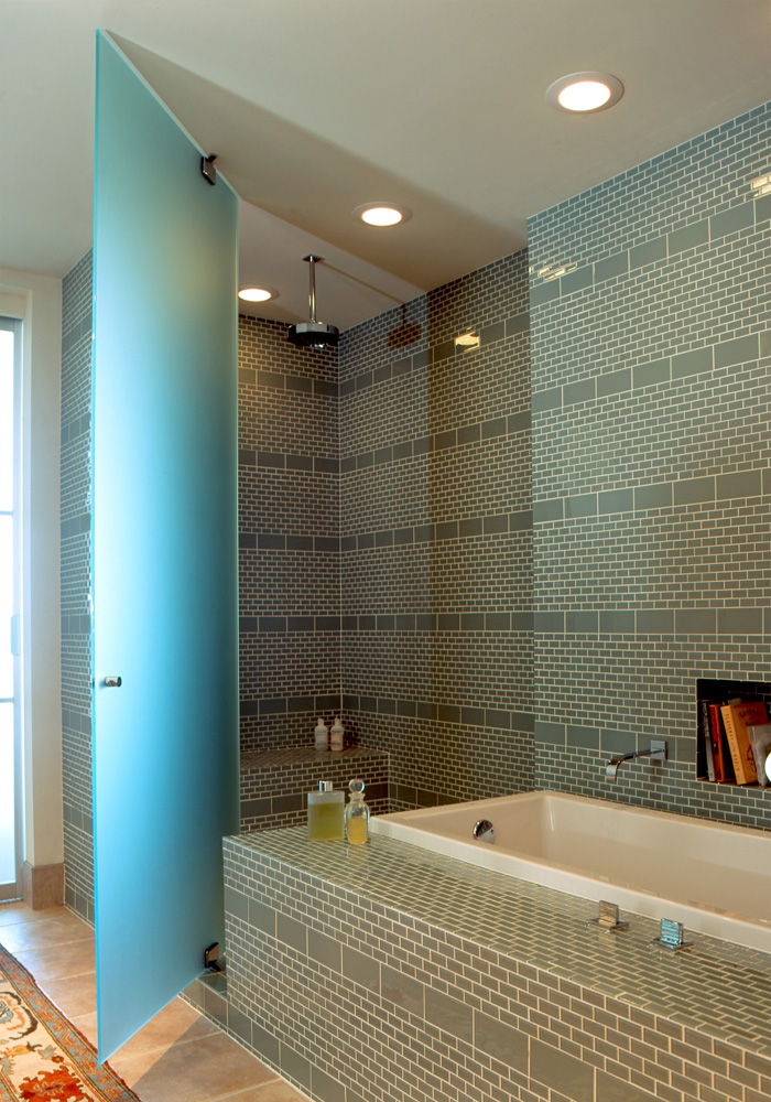 A tiled shower and tub combination bathroom.