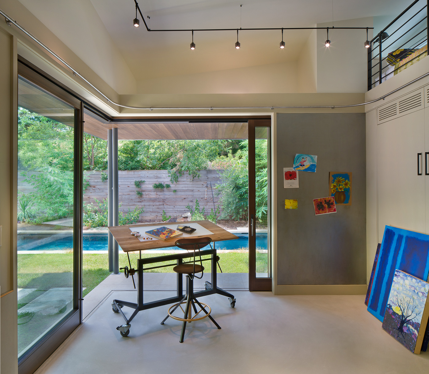 An art studio's view to backyard pool.