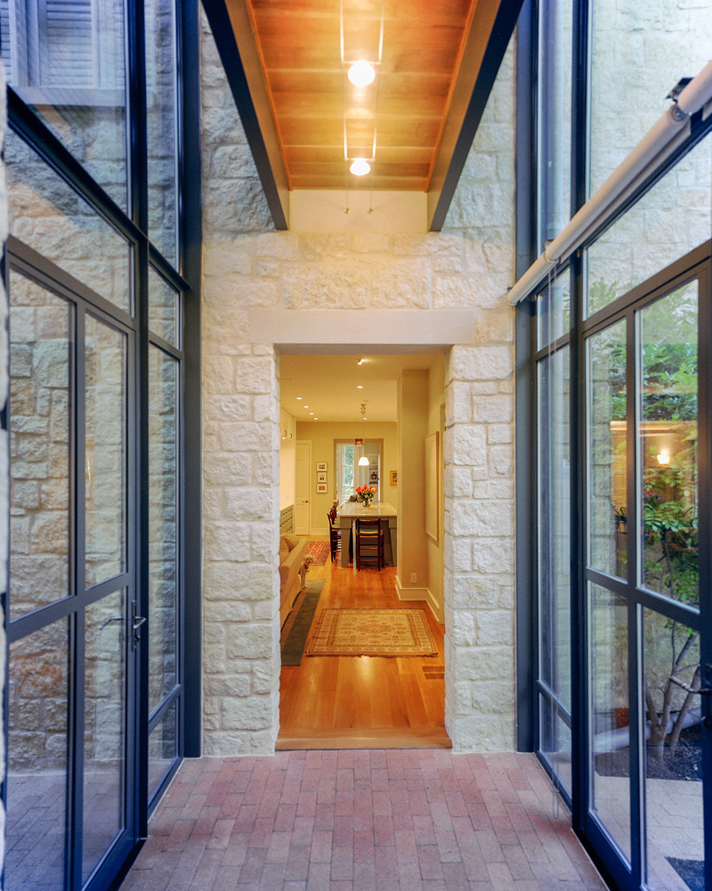 A glass walkway connecting addition of home.