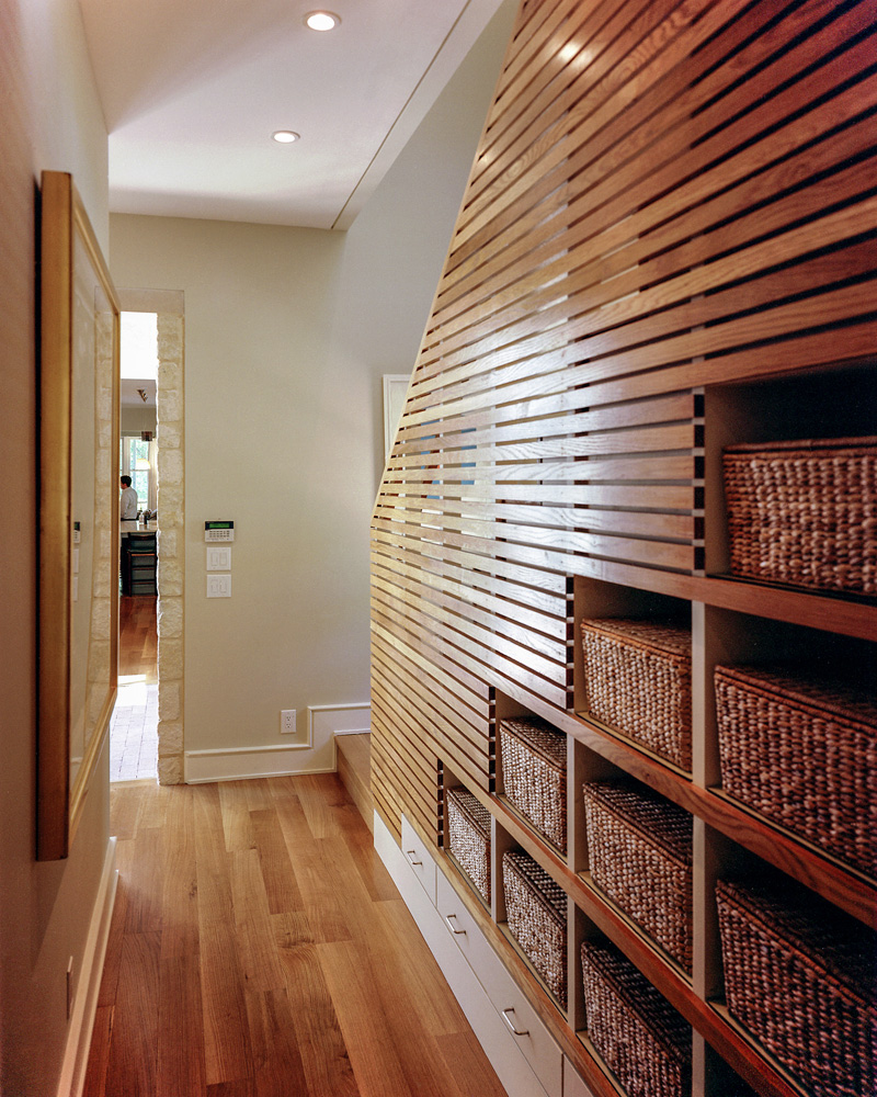 A wooden hallway and connected stair set of a home.