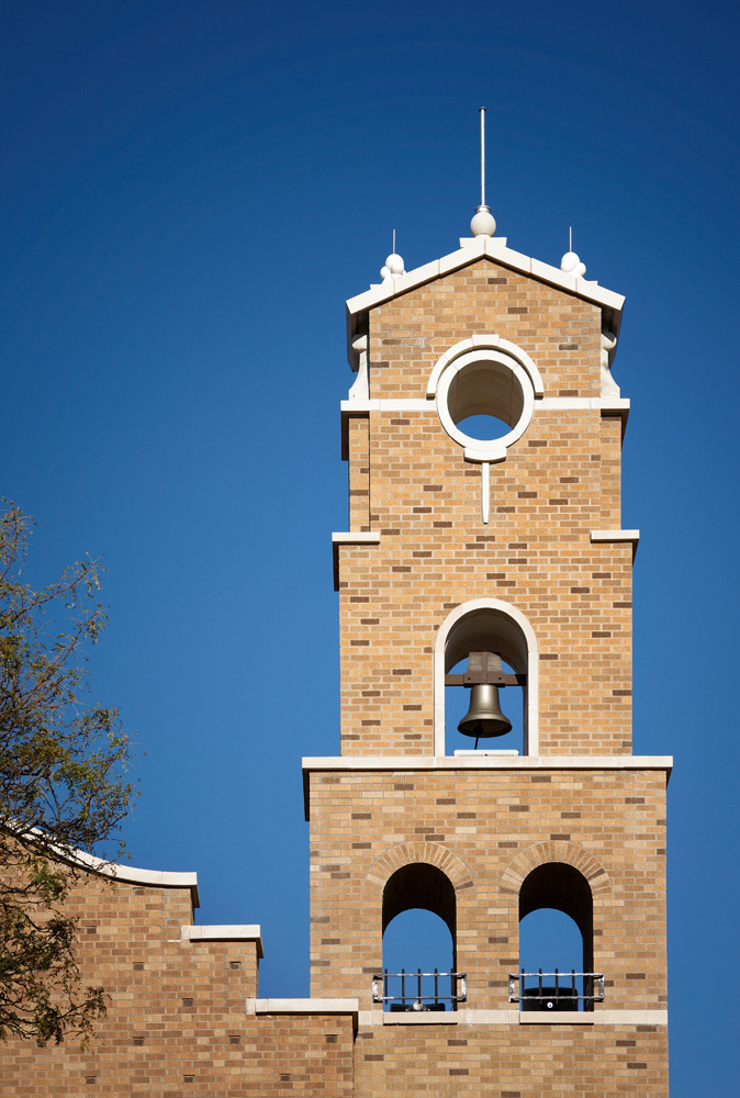Close up image of a brick chapels bell tower.