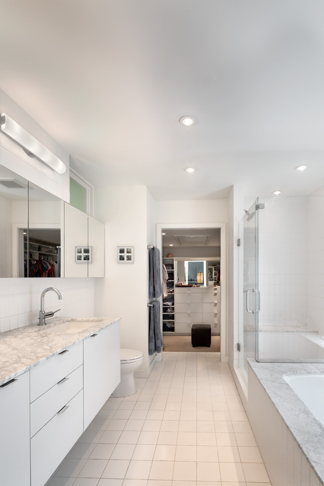 Master bathroom with glass shower and separate bathtub.