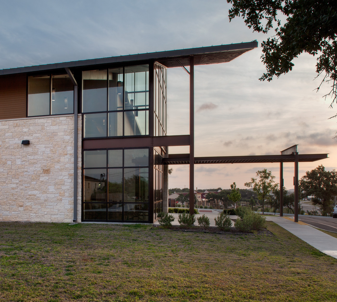 Side profile of a metal and glass front entrance to a building.