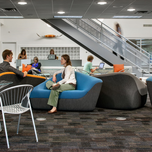 People working in seating space at a university.