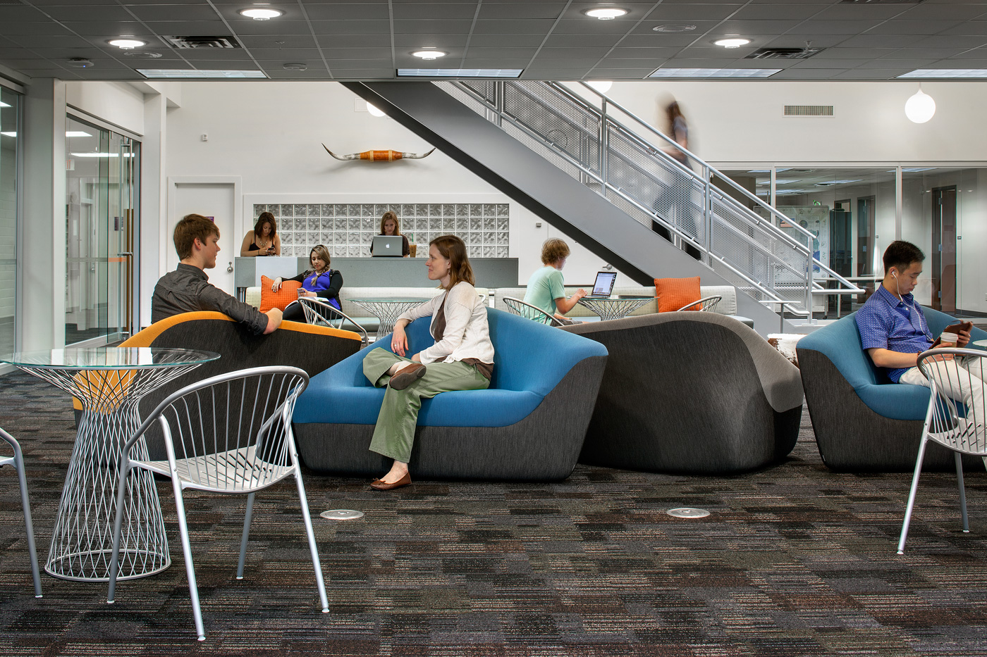 People working in seating space at a university.