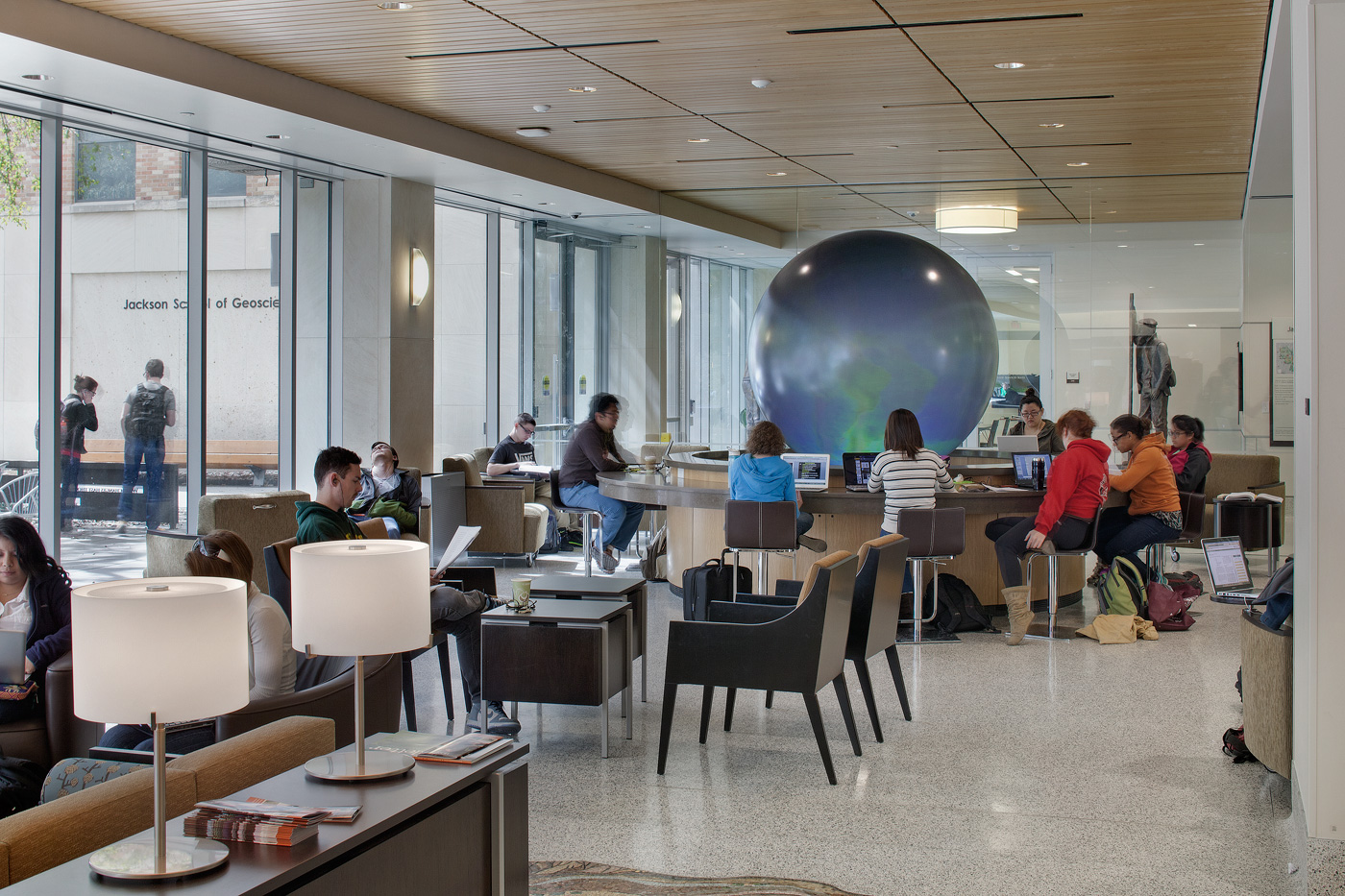 Students working at desks and table of a student center.