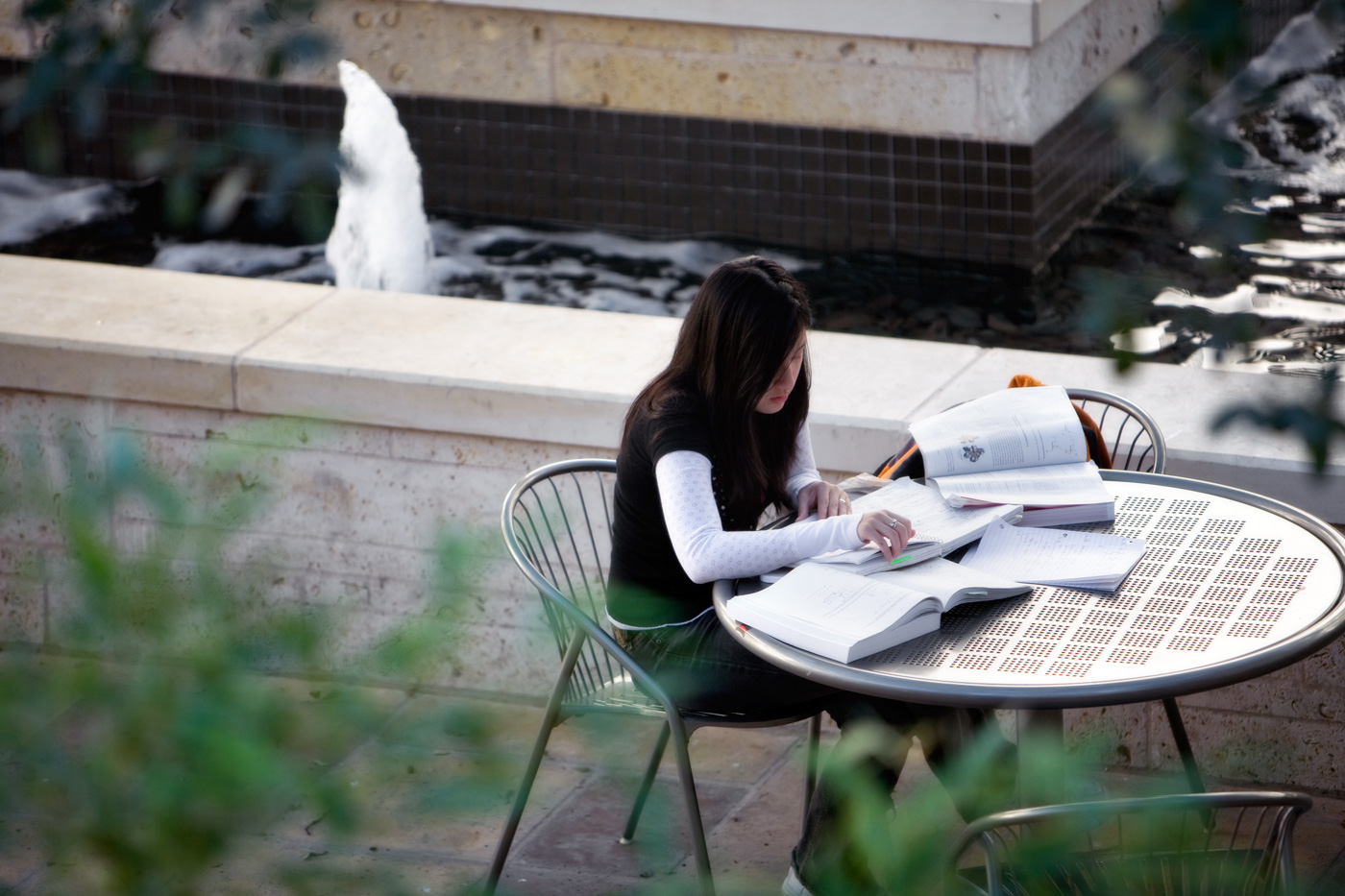 A student studying at a patio table.