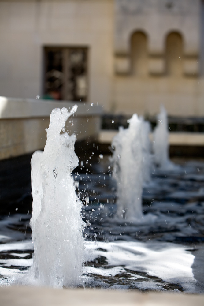 A small exterior fountain shooting up water.
