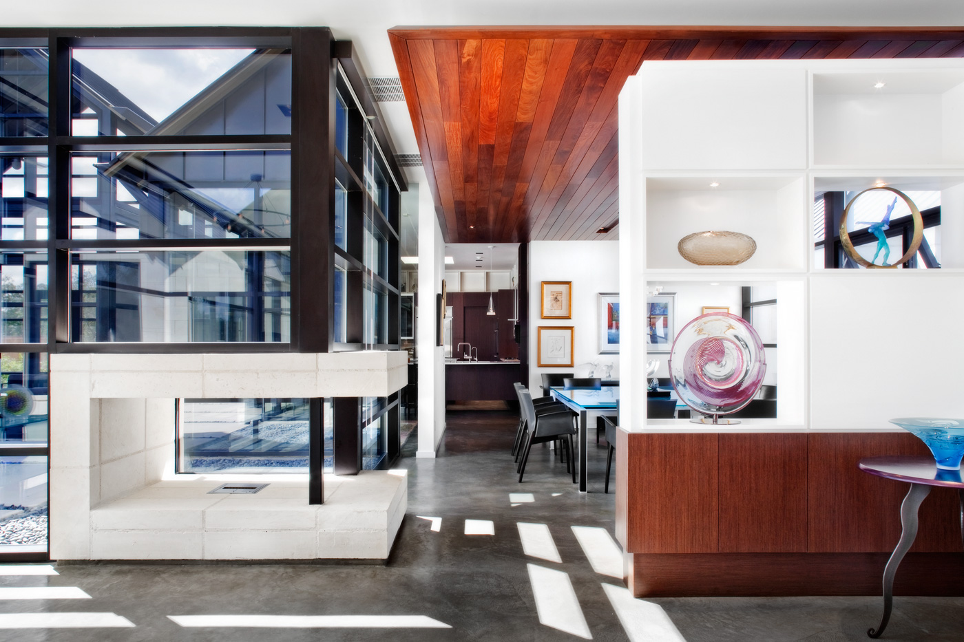 Modern homes walk from living room through dining room to kitchen in the distance.