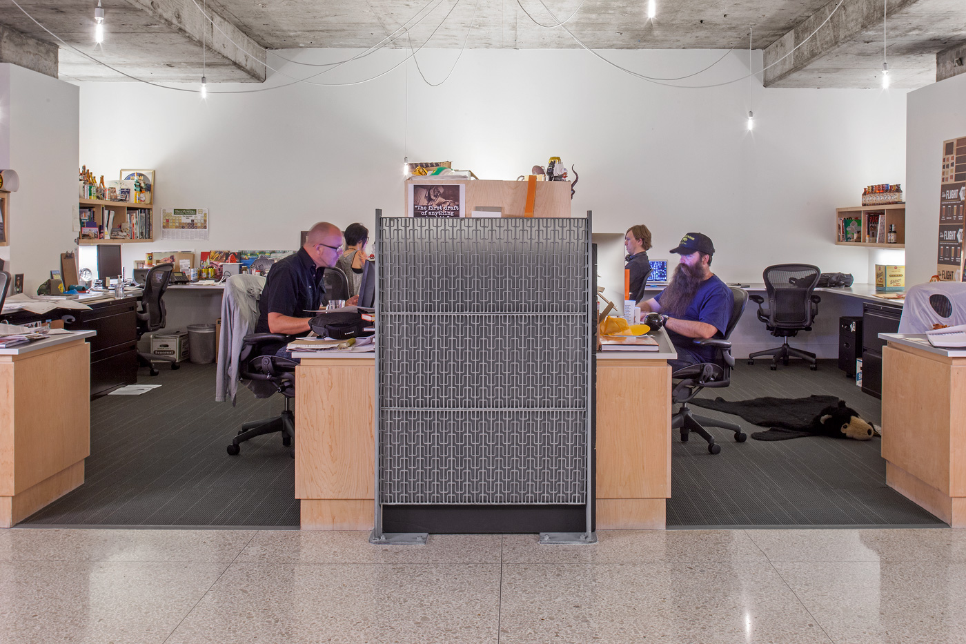 People working in individualized cubicles.