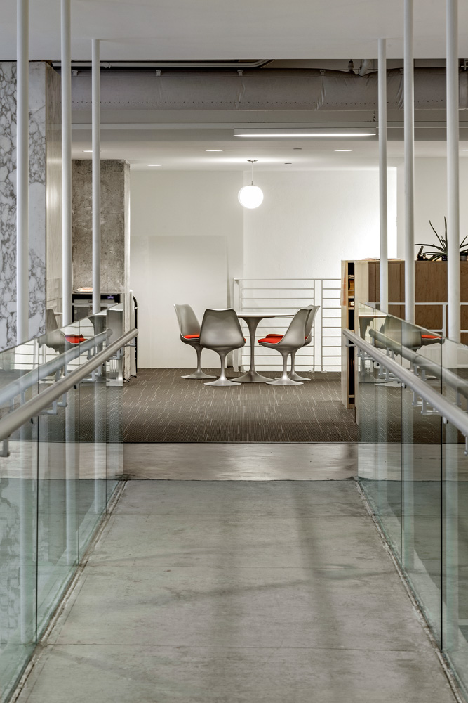 A concrete walkway bridge in an office building.