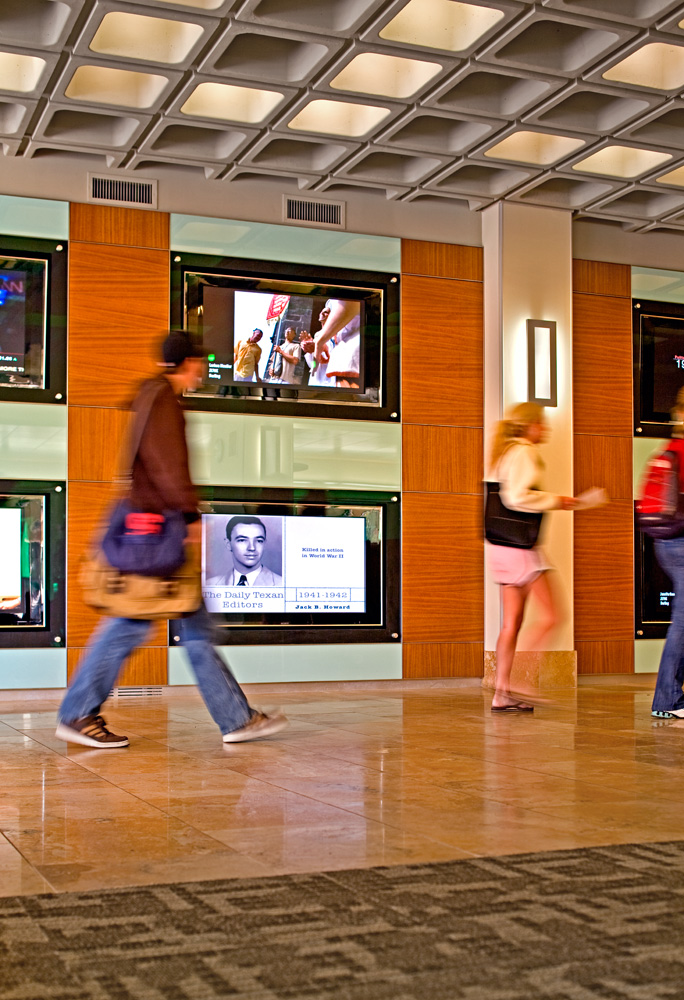 People walking through a lobby walkway.