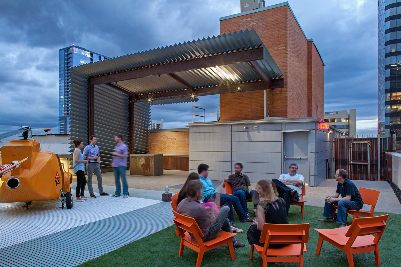 People socializing on a downtown rooftop deck at duck.