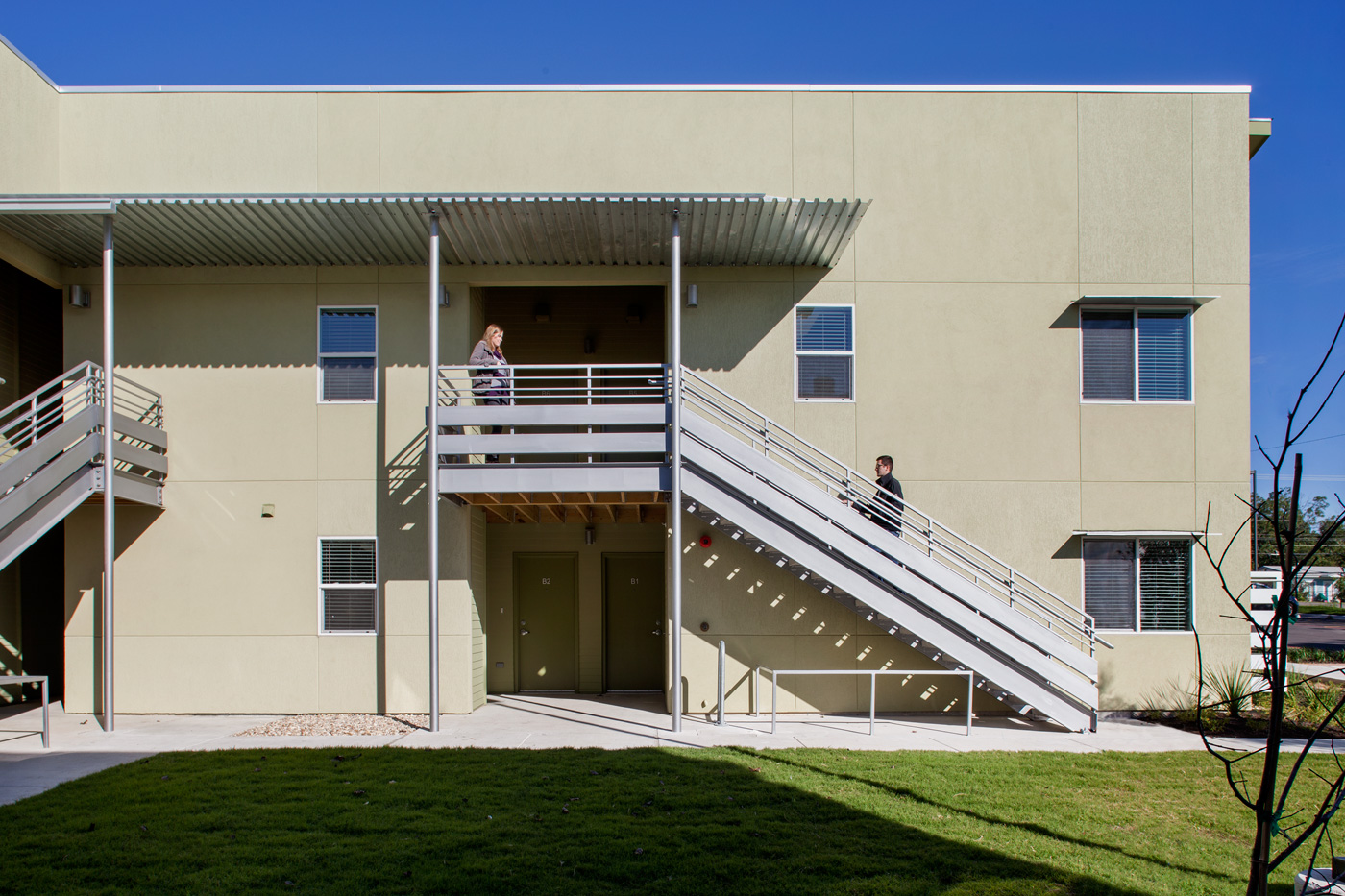 People using exterior staircase of an apartment development.