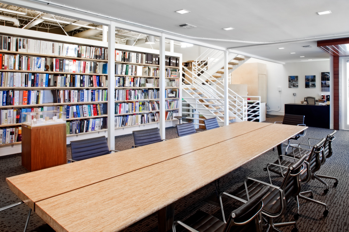 Open office conference room with large bookshelf.