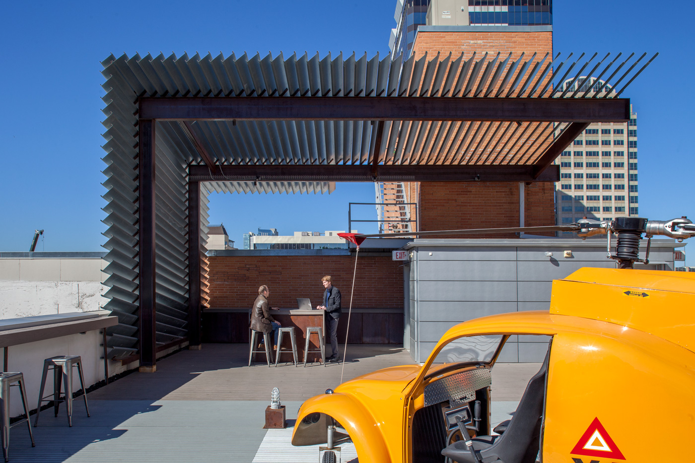 People socializing on a downtown rooftop deck.