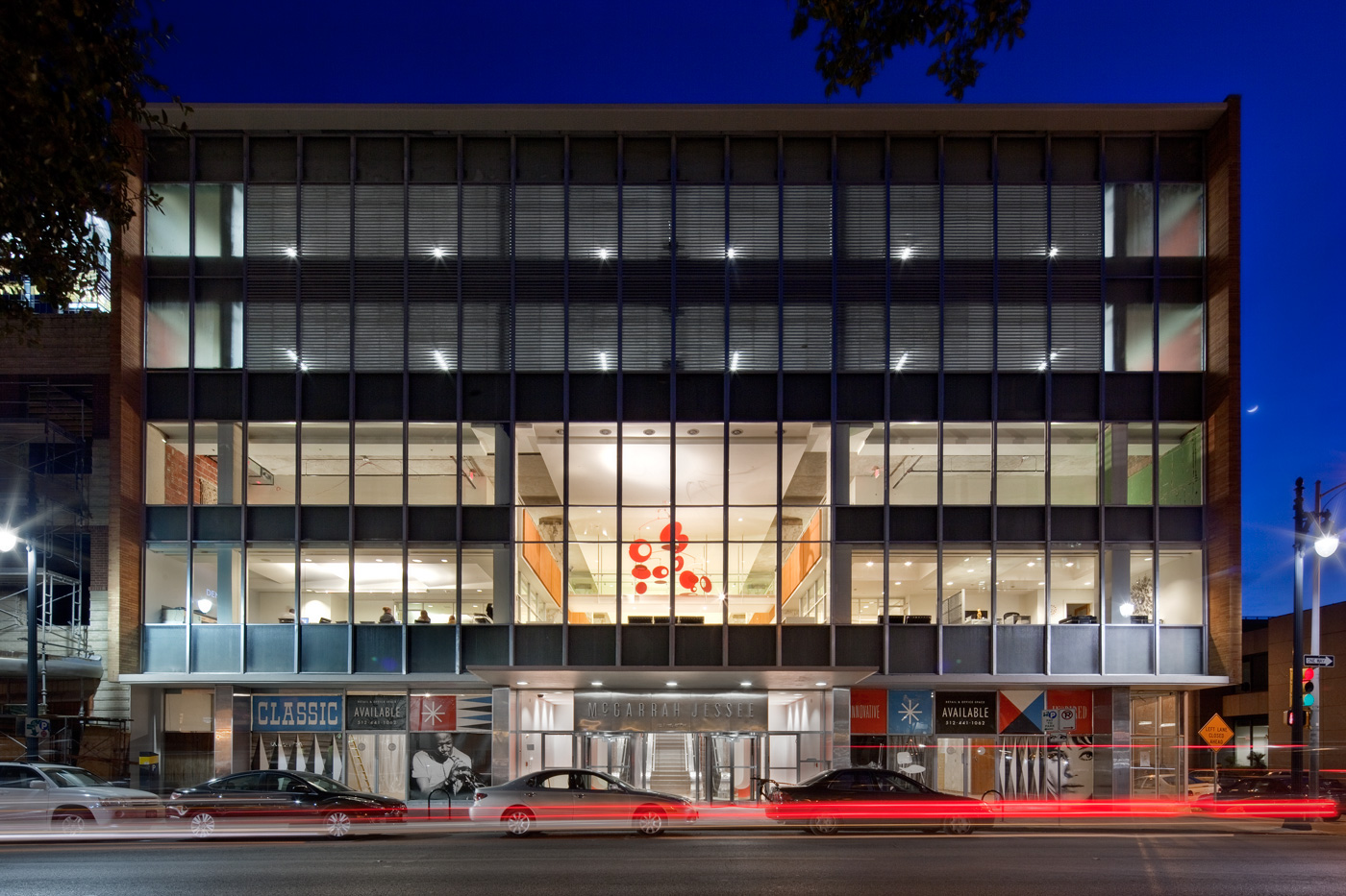 Front view of office building across street at night.