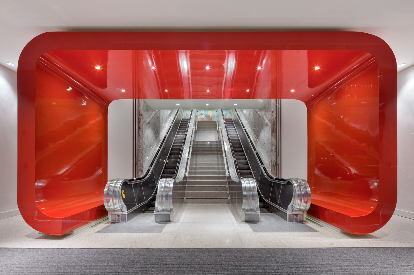 Statement red sculptural entrance to office buildings escalators.