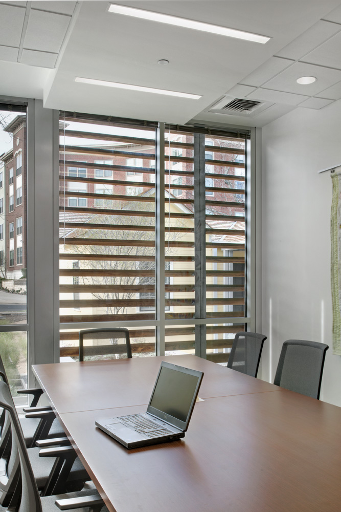 A computer on a medium sized conference table.