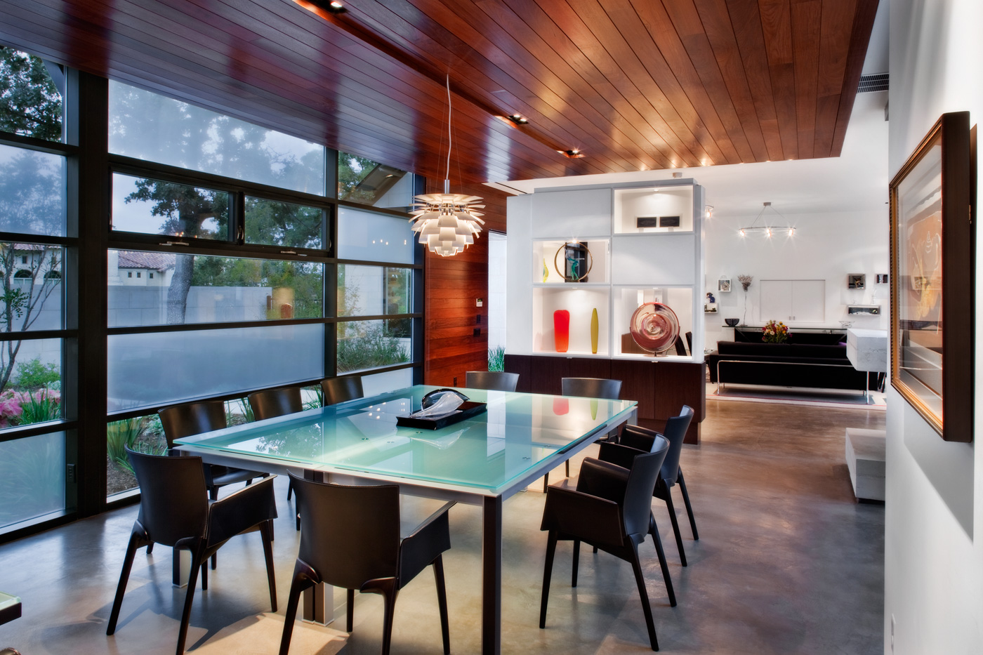 Glass dining table with small modern glass chandelier.