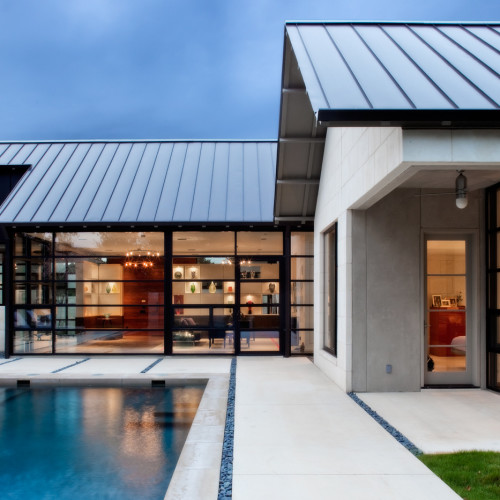 A homes backyard pavers connecting it to a pool