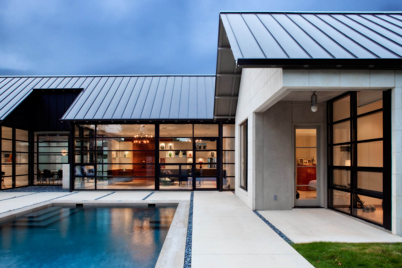 A homes backyard pavers connecting it to a pool