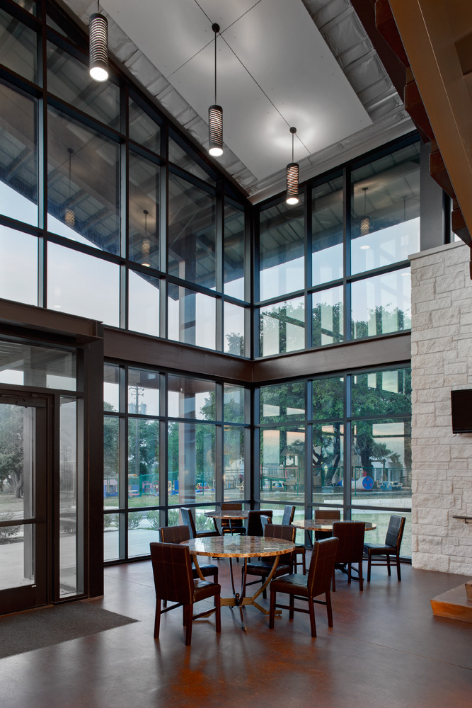 Chairs around two tables in the front lobby area of a building.