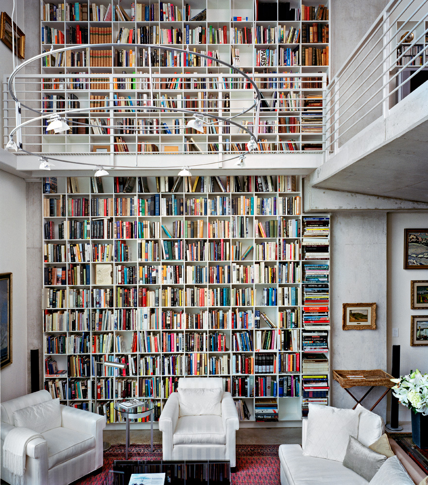 A large two floor bookshelf in an apartment.