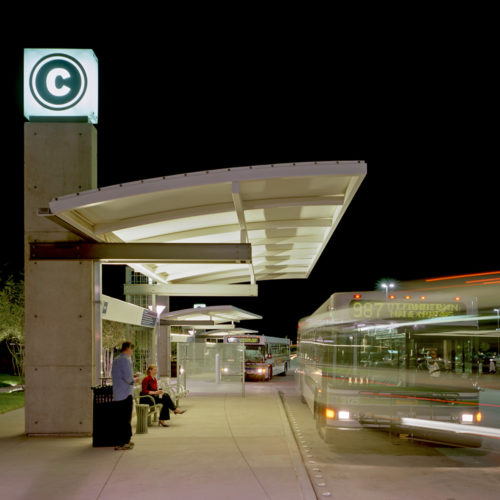 Buses picking passengers up at station.