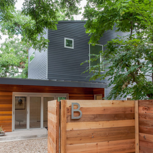 A modern house fenced in with a fence titled "B".