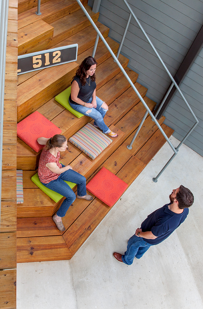 People talking at wooden steps.