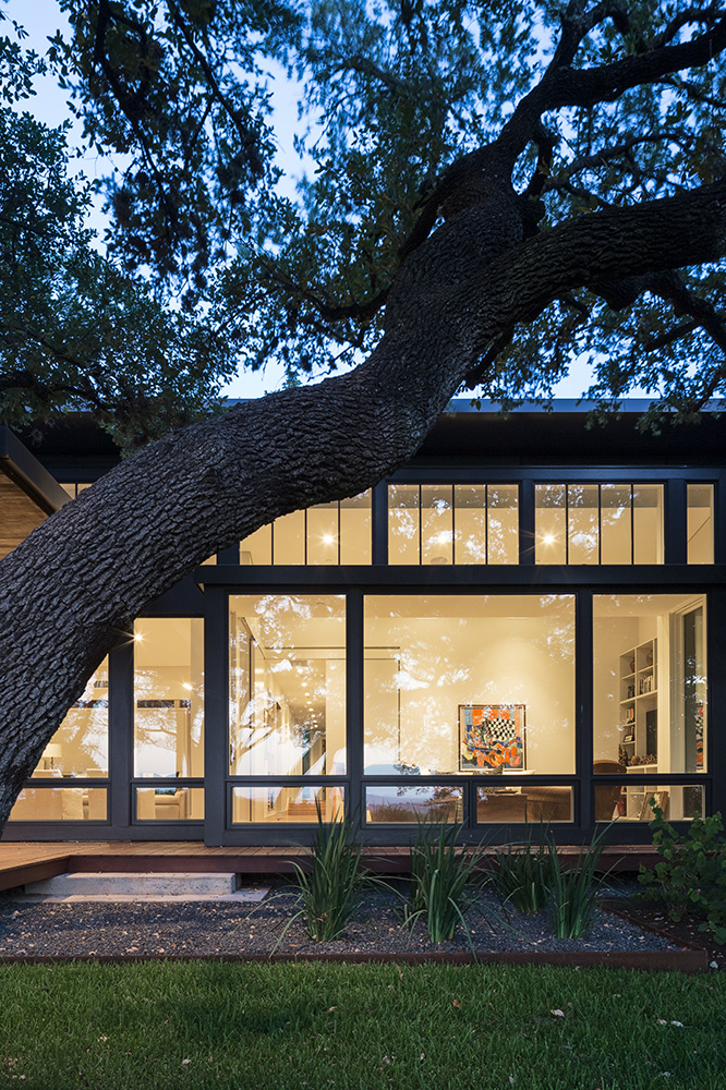 large windows look into the living area of a home.