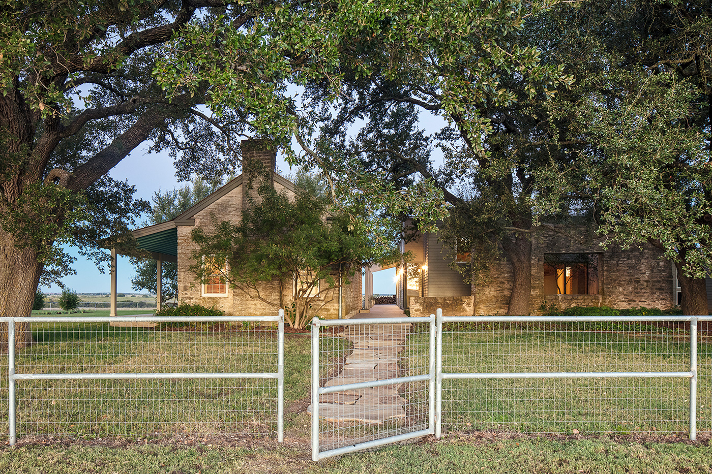 A pathway from a front gate to a house.