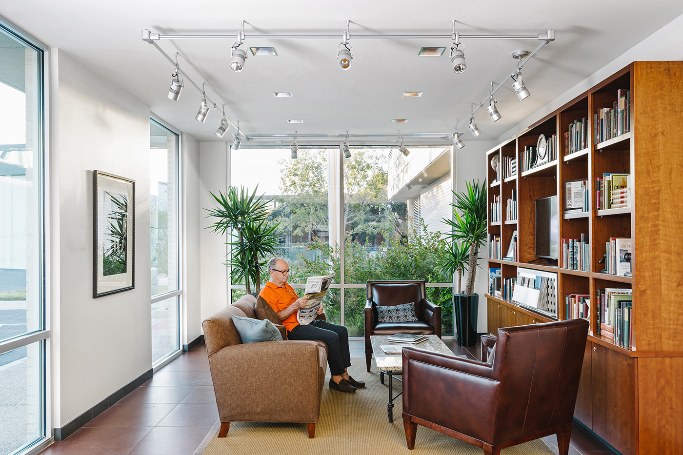 Someone reading in a lobby space.