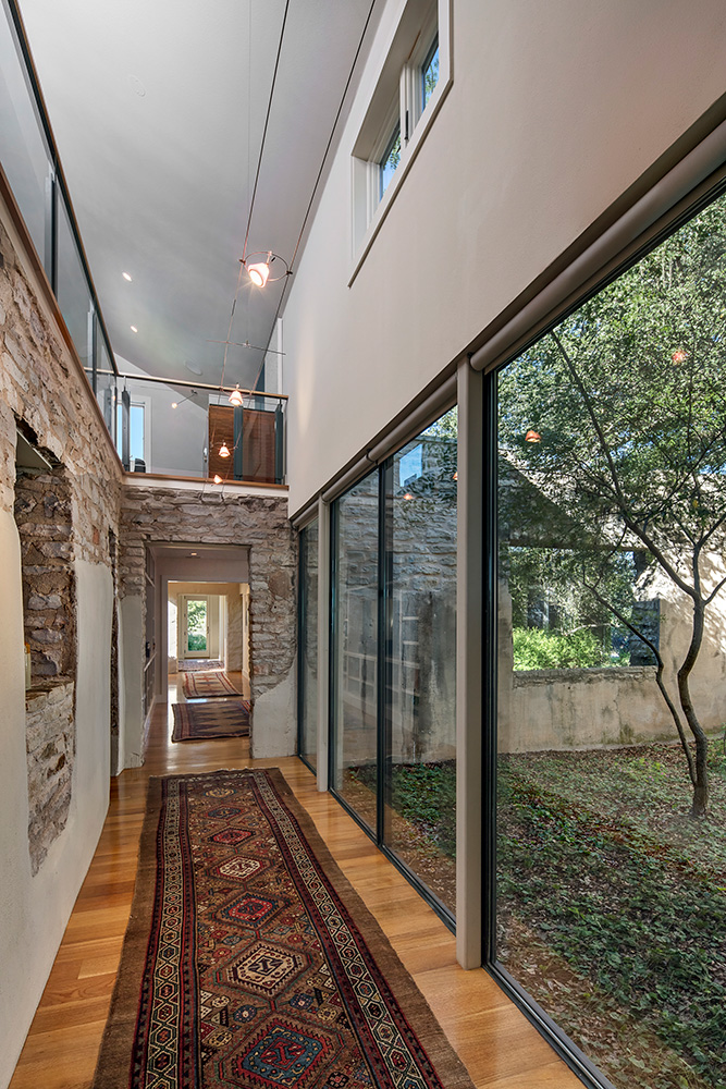 The hallways of a home with exposed brick.