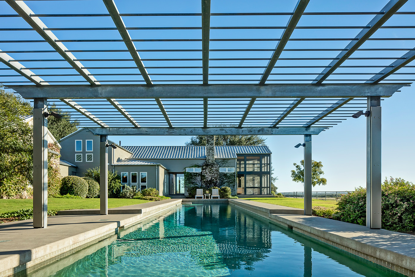 A long pool next to a house.