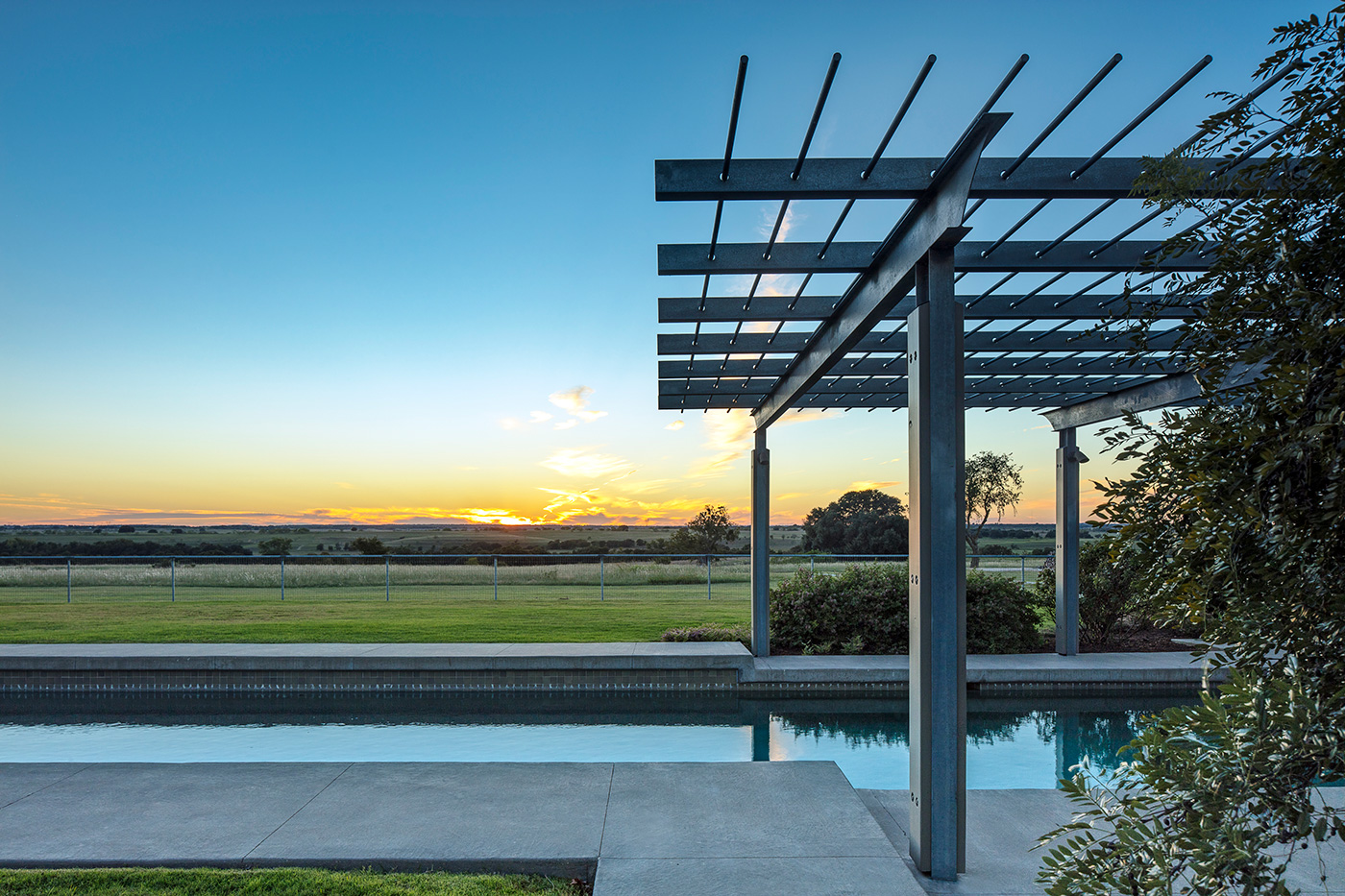 A pools view of a ranch property.