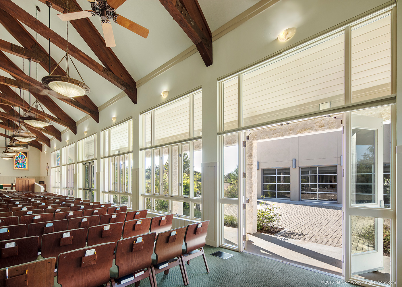 Wall of windows to the courtway in a church.