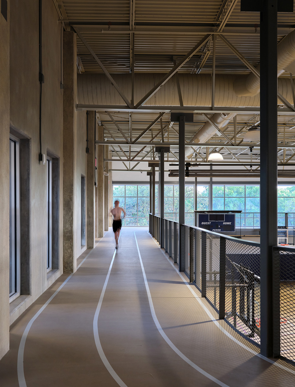 Man running on second floor indoor track.