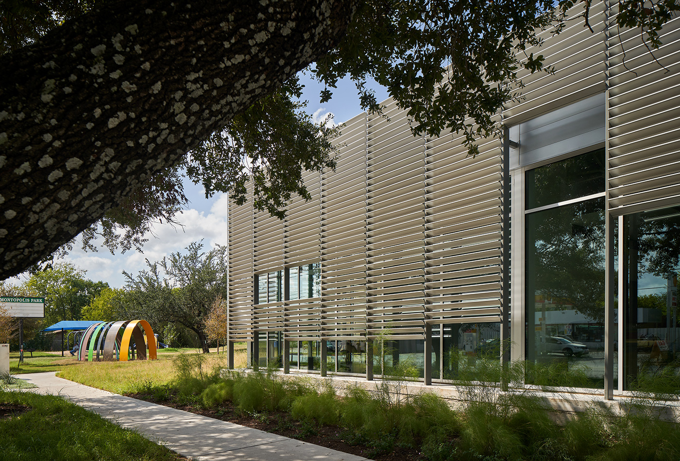 Buildings metal exterior panels shading wall of windows.