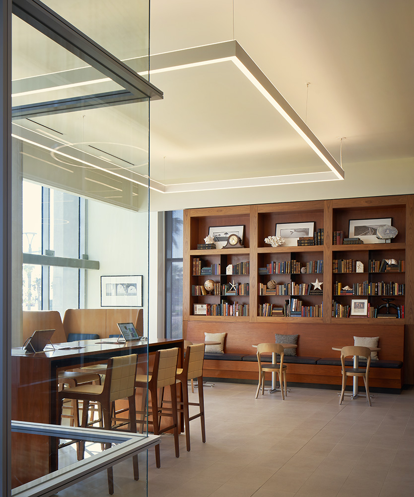 A room in an office building with a bookshelf against a wall.