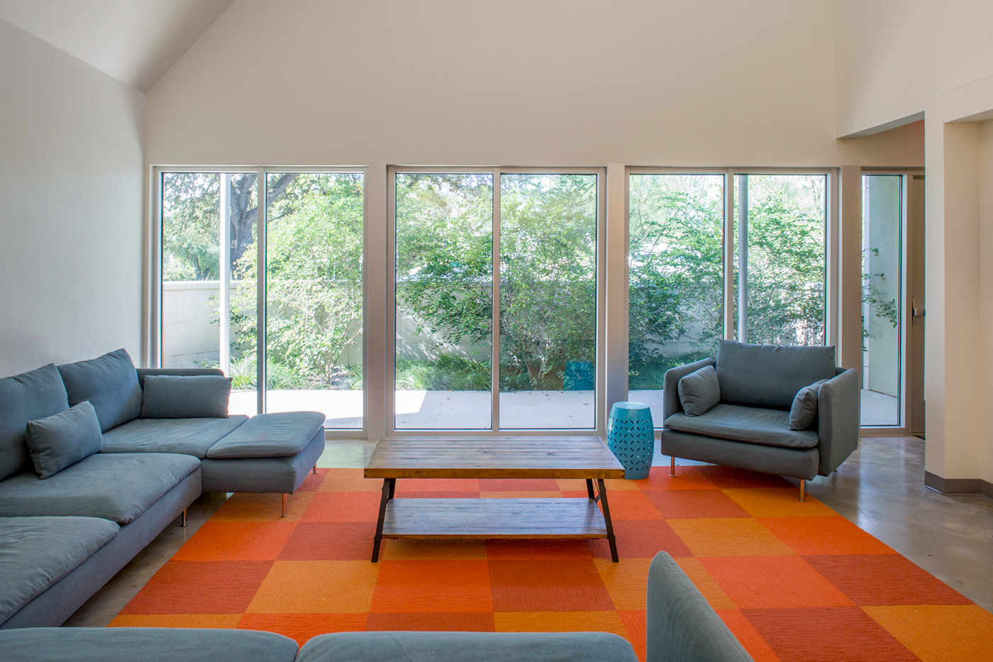 Seating area with a bright accent carpet.