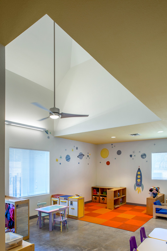 Playroom with space graphics on wall.