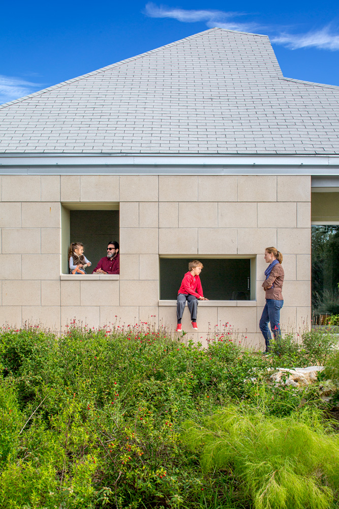 Parents and children talking outside of building.